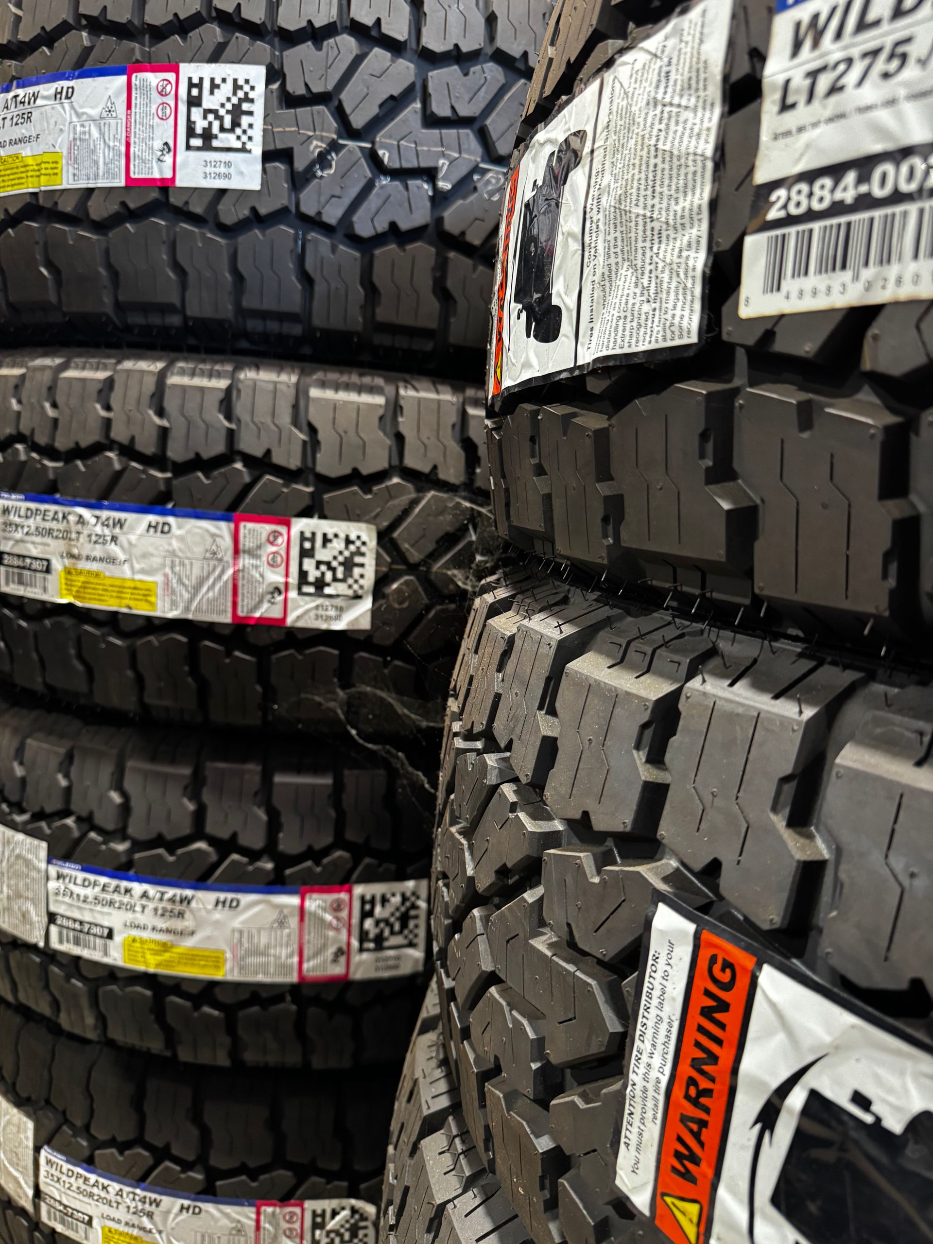 A stack of tires with warning labels on them