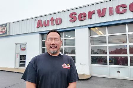 Man in black shirt stands in front of 