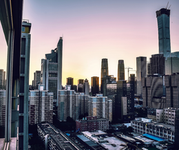 An aerial view of a city skyline at sunset