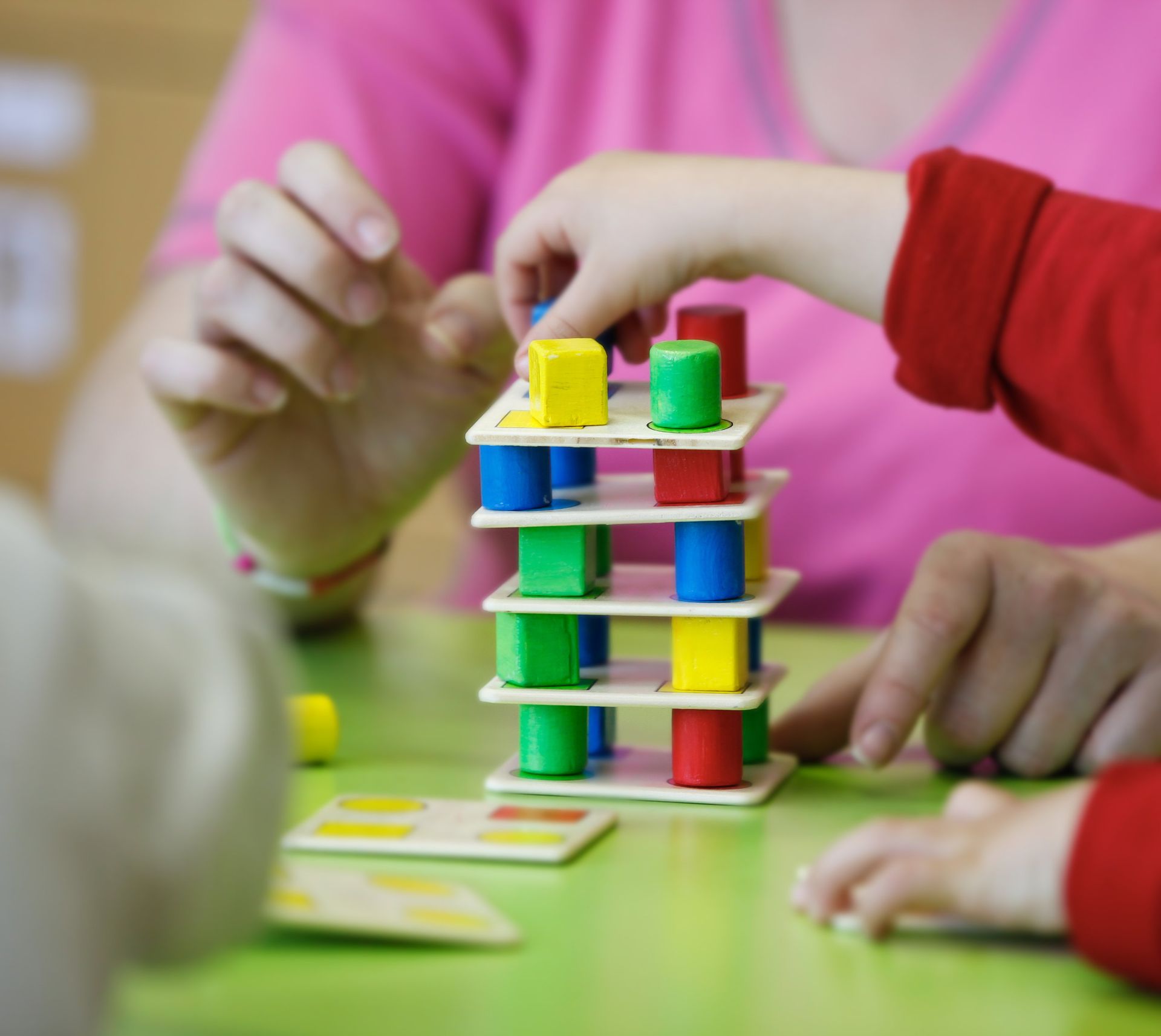 child learning balance and motor skills with colored blocks