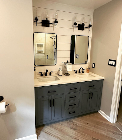 A bathroom with two sinks and two mirrors.