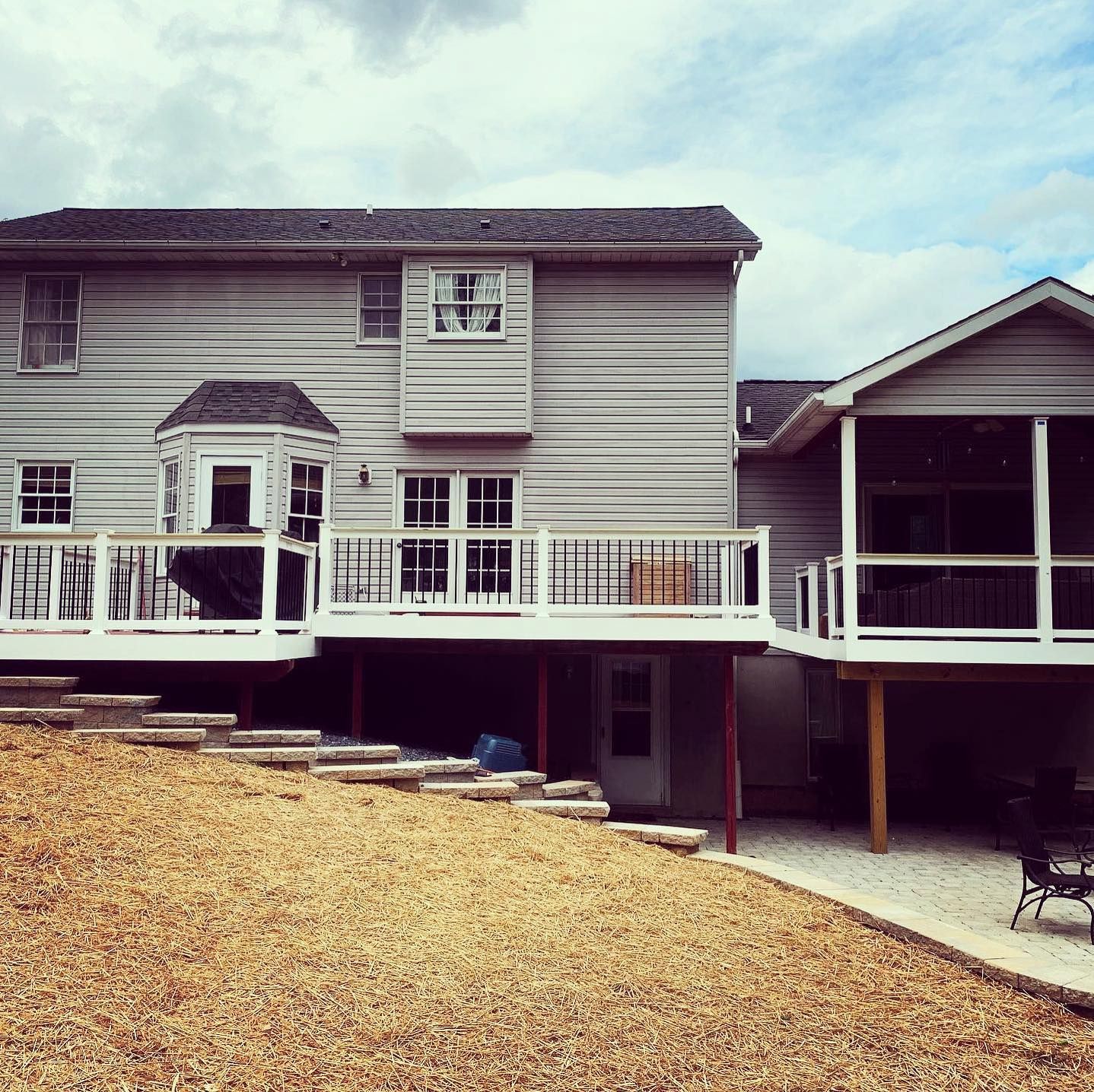 A house with a large deck and stairs leading up to it