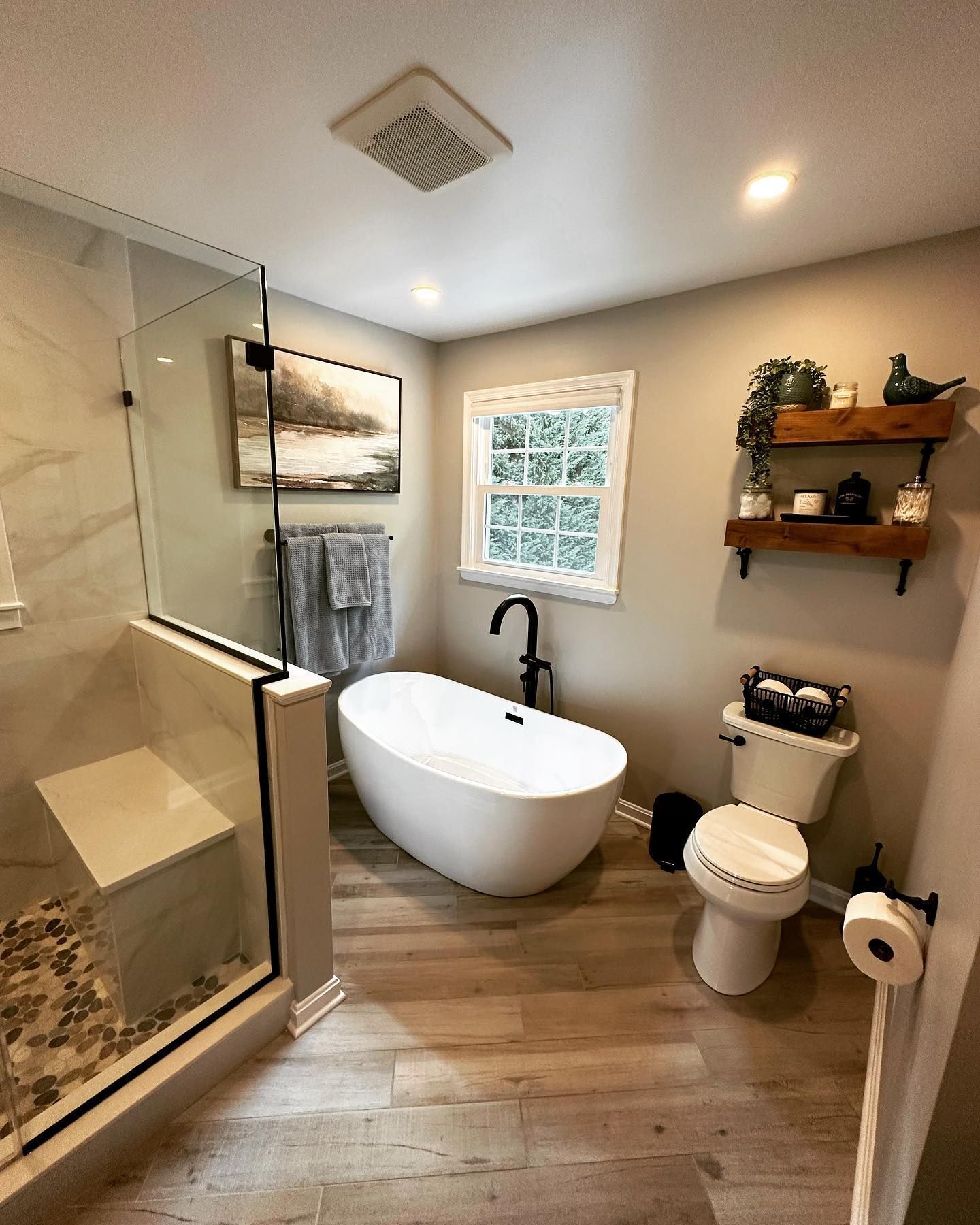 A bathroom with a tub , toilet , and shower.