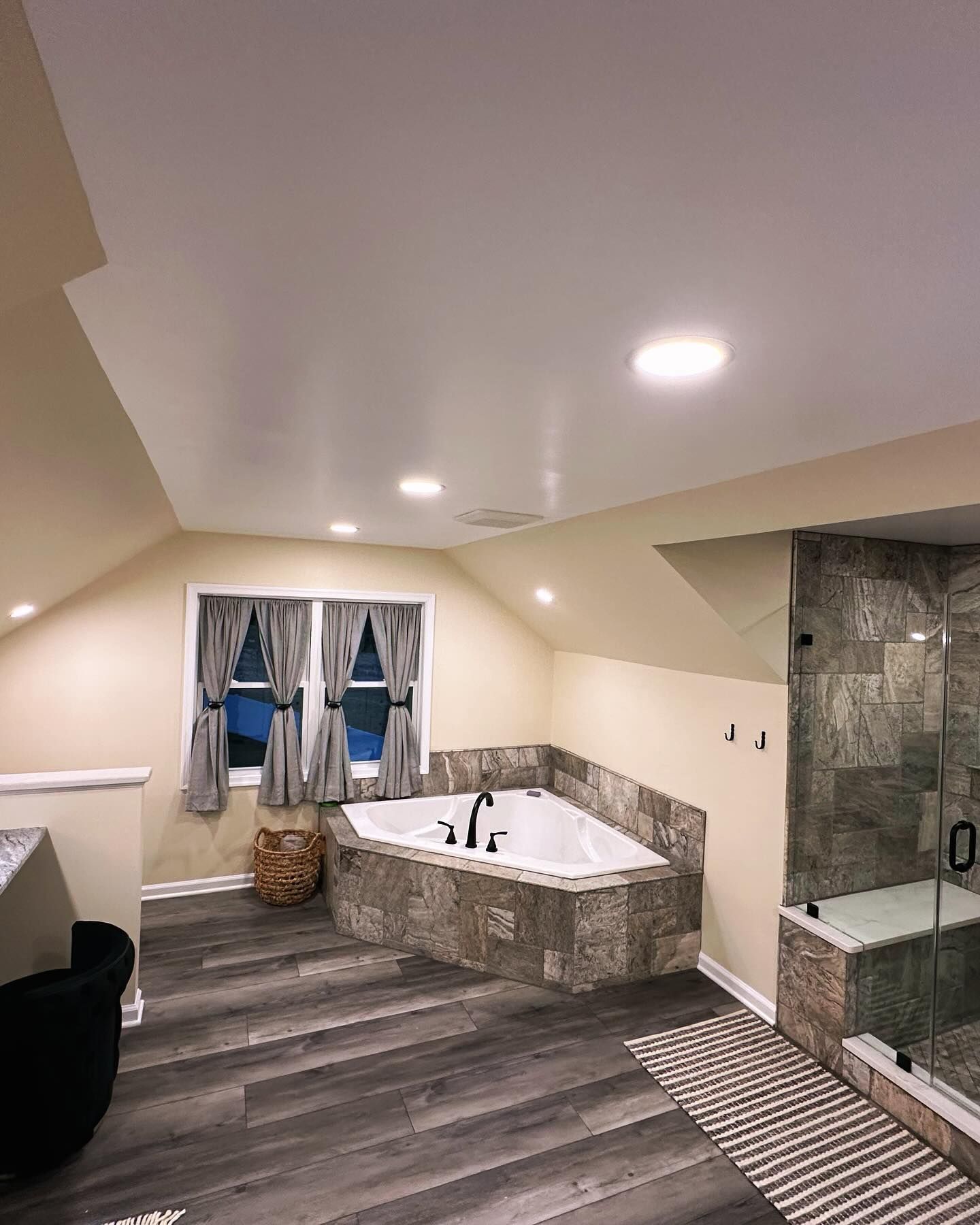 A bathroom with a jacuzzi tub and a walk in shower.