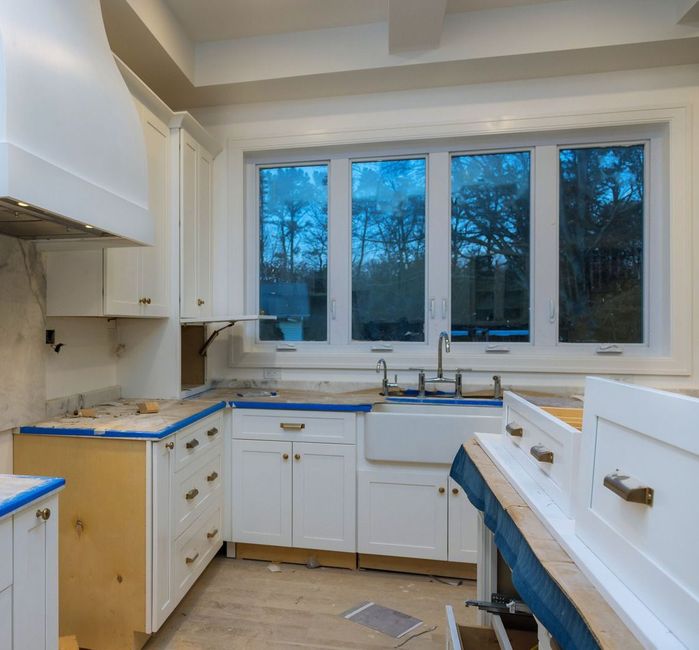 A kitchen with white cabinets and blue counter tops