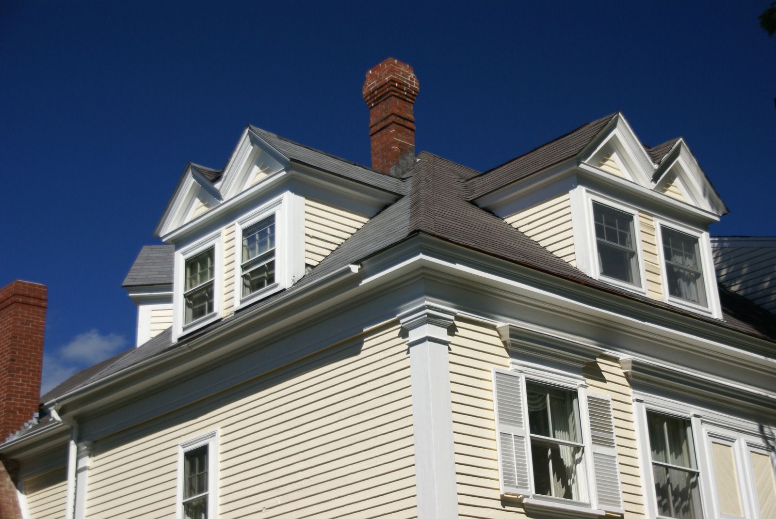 A large house with a chimney on top of it