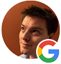 A person looking upward next to a Google logo in a circular frame against a solid dark orange background.