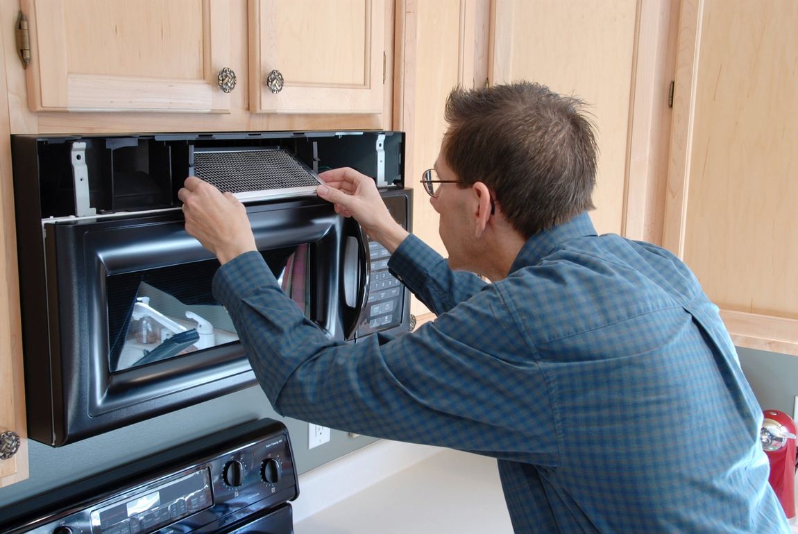 Appliance Repair — Man Repairing Oven Toaster in Dallas, TX