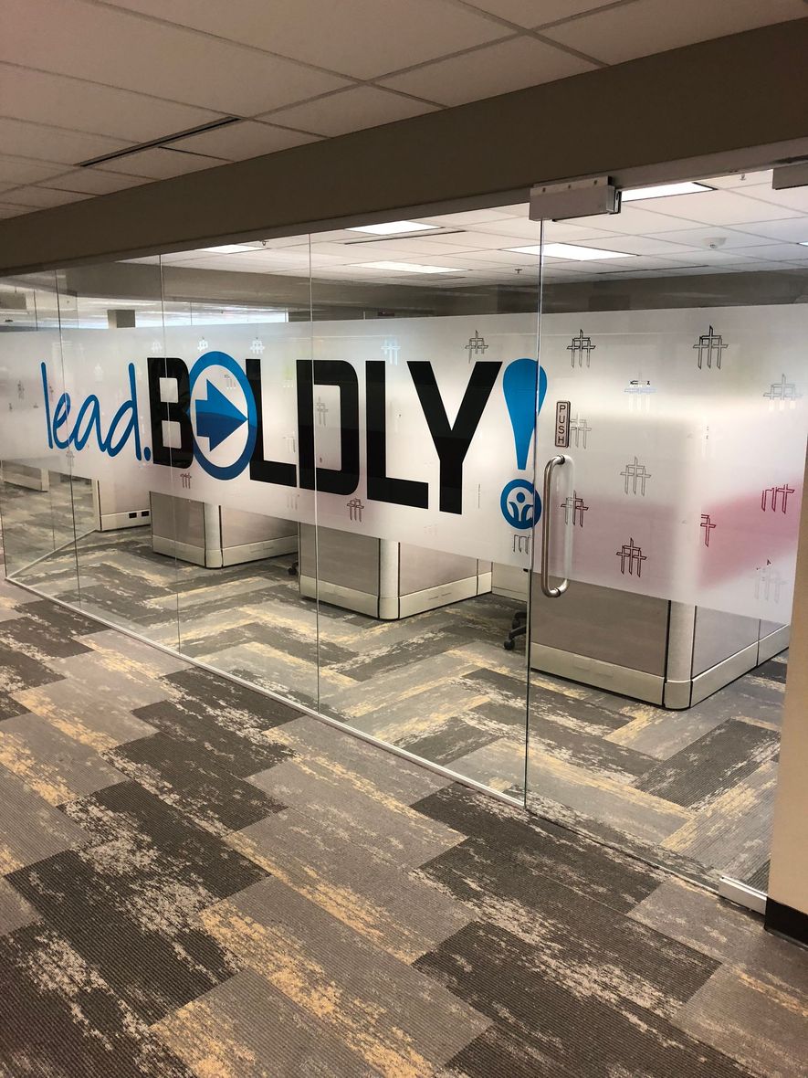 Office space with glass walls displaying 