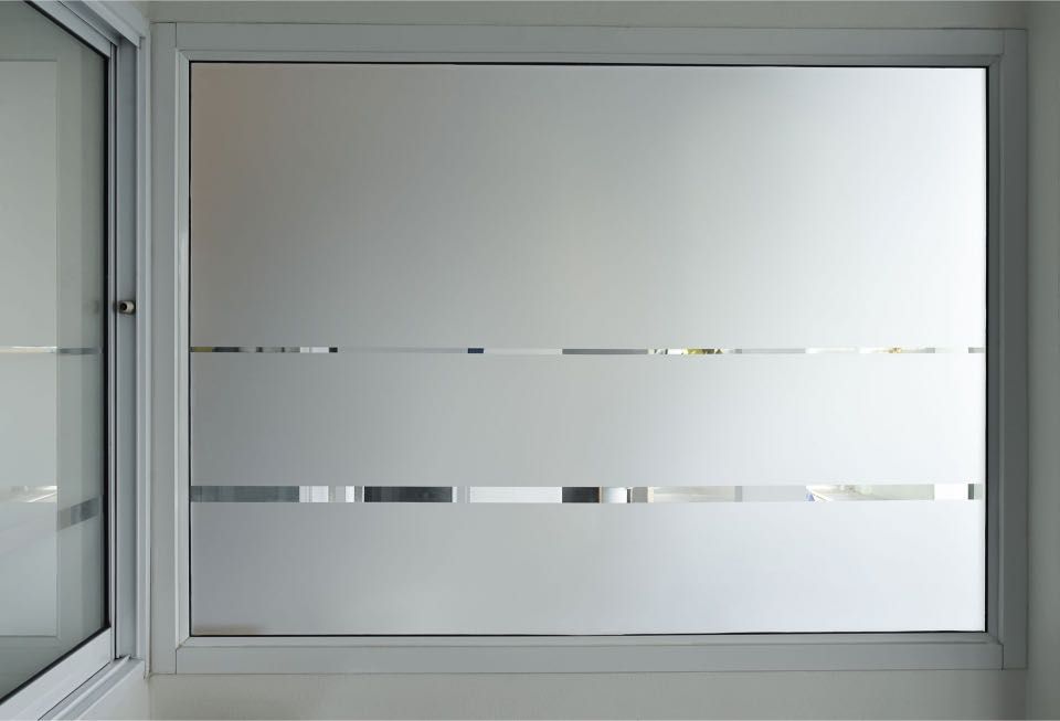 Frosted window with horizontal stripes, providing privacy while still allowing light in.