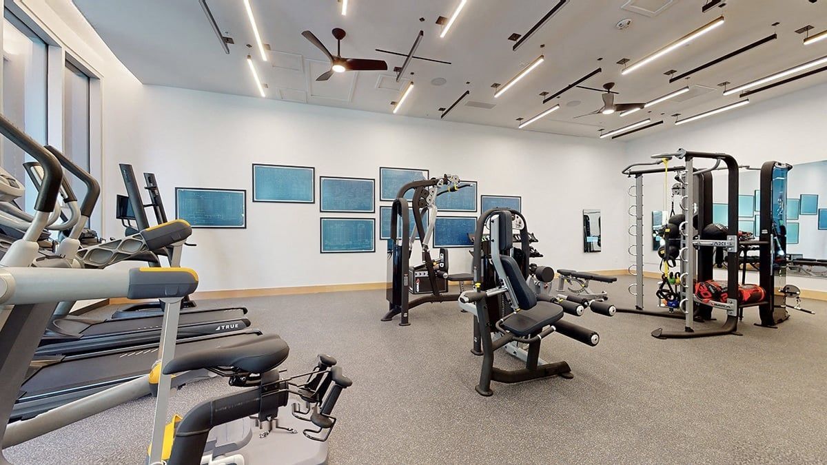 A gym with treadmills, weights, and exercise machines.