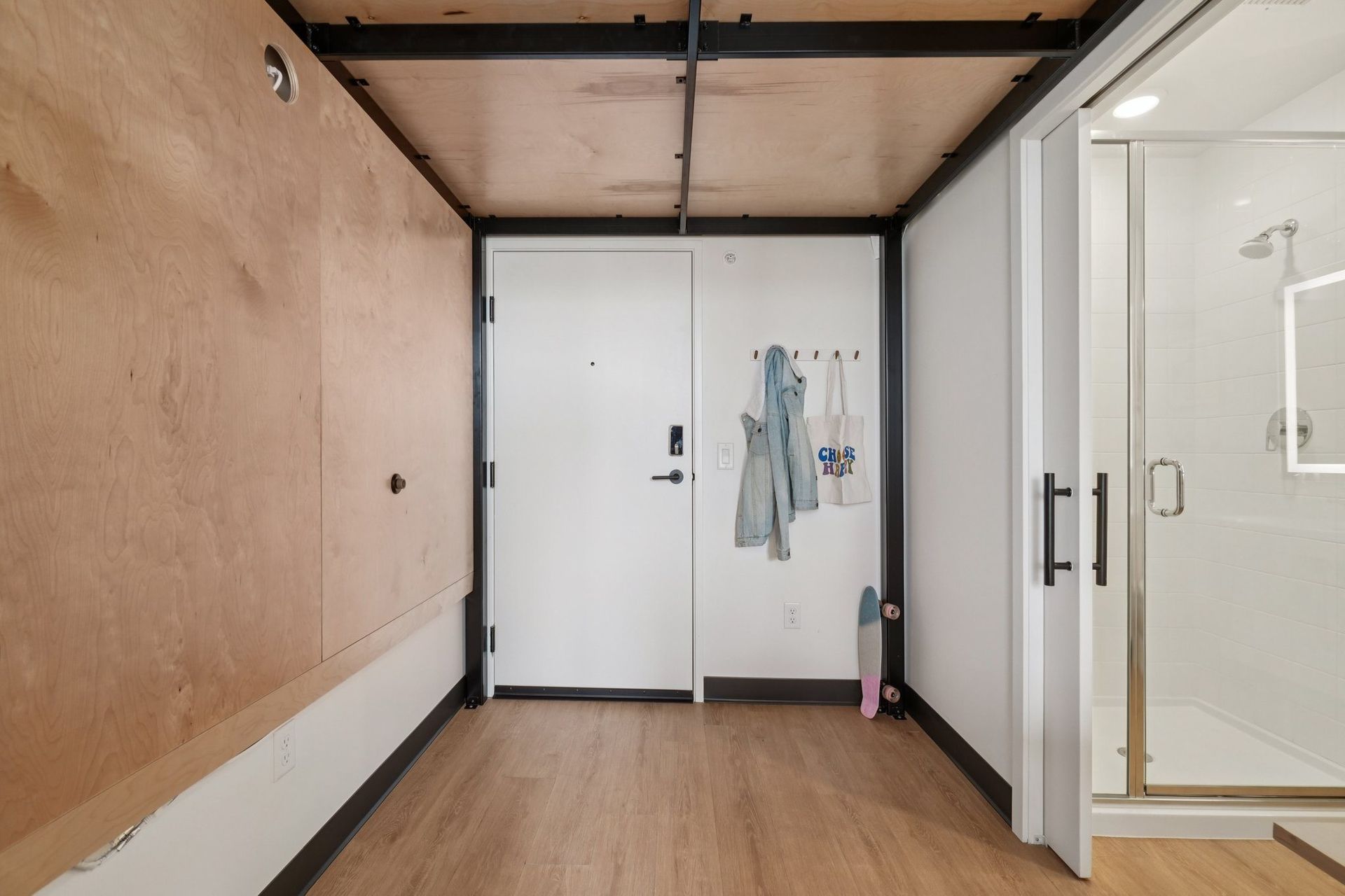 A white door is open to a bathroom.