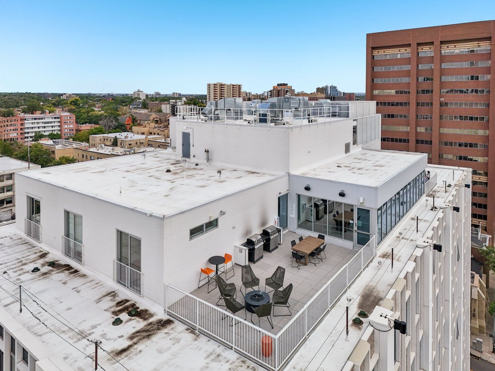 A white building with a patio and a table set up for dining.