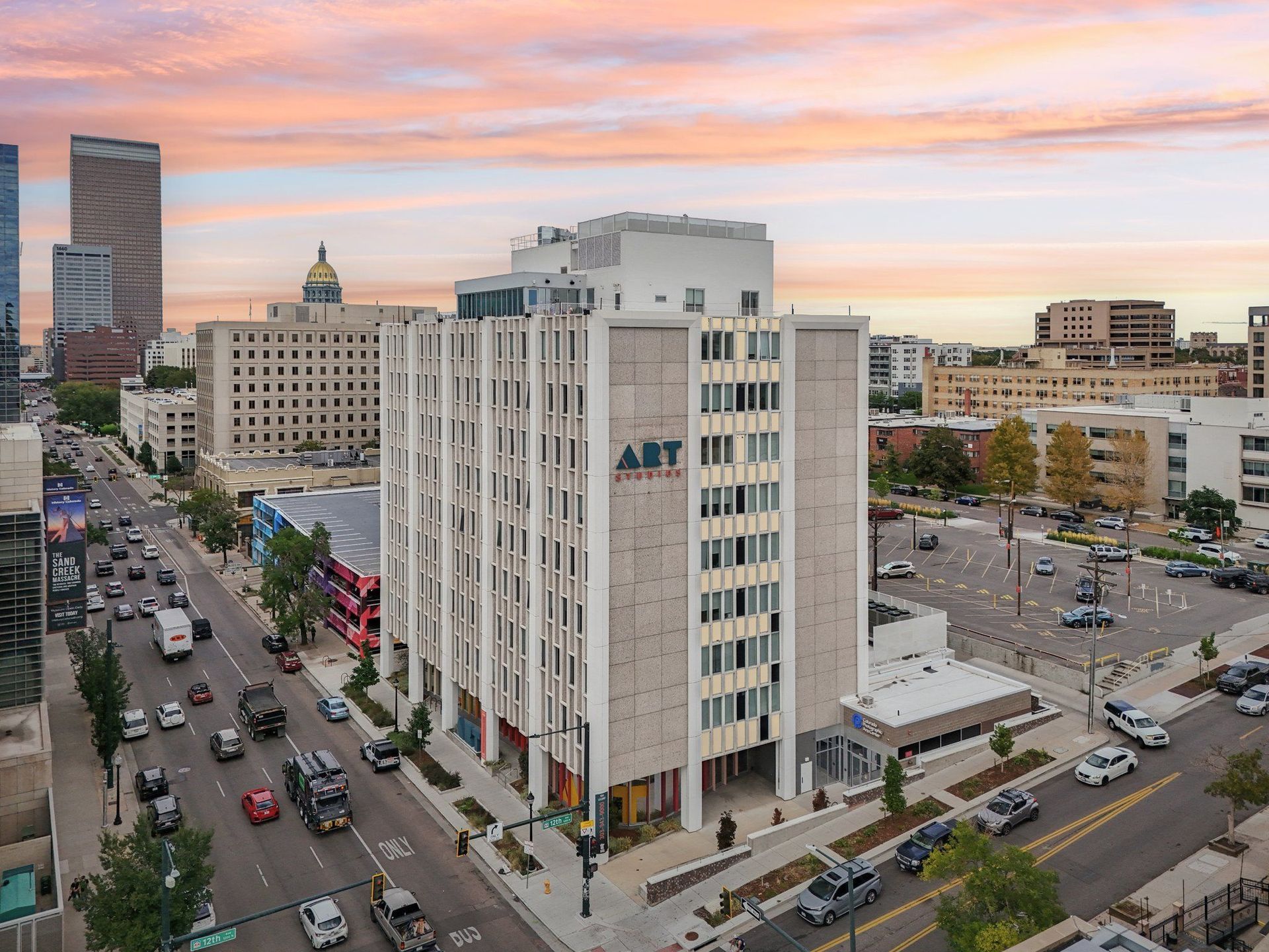 A busy city street with cars and buildings.
