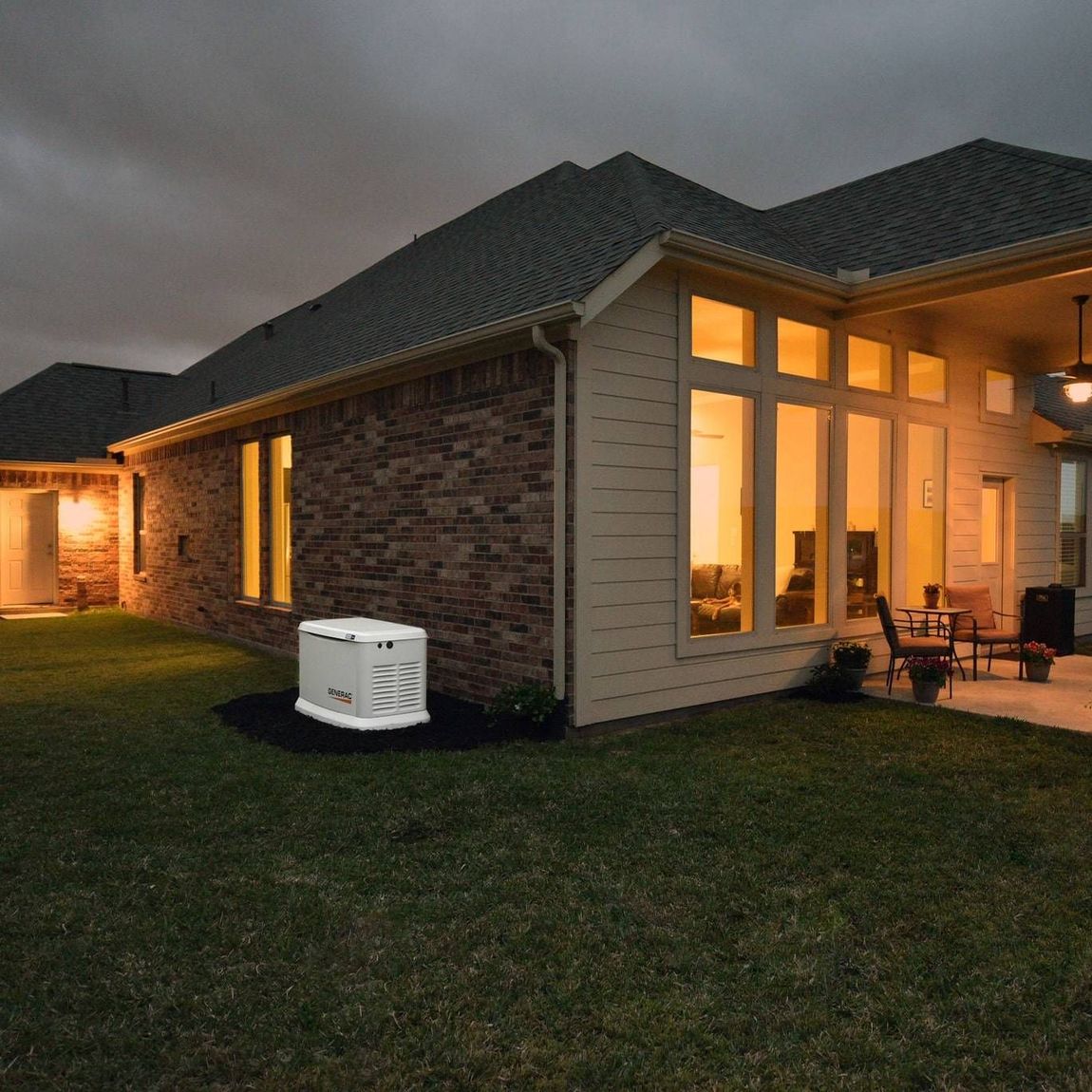 A house with a generator in the backyard at night