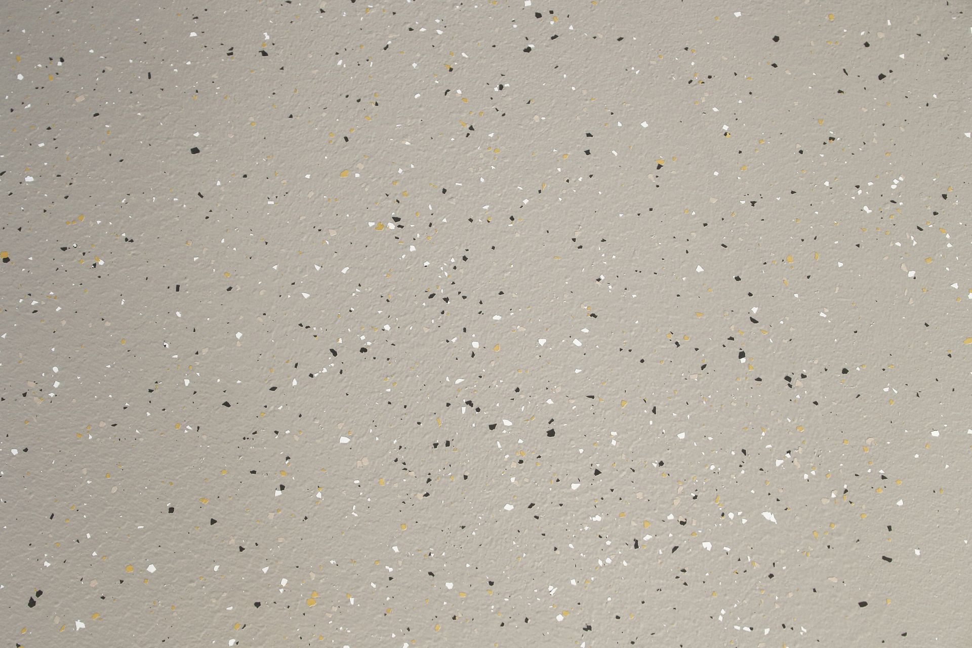 Gray floor with small black and white flecks.
