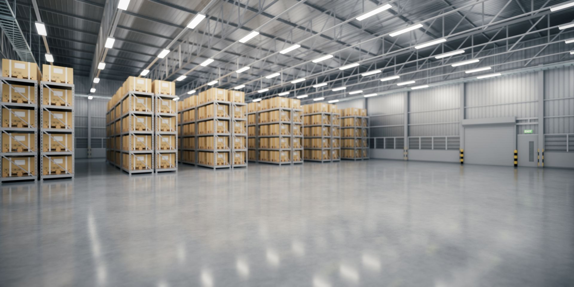 Warehouse interior with stacks of cardboard boxes on shelves, and a polished concrete floor.
