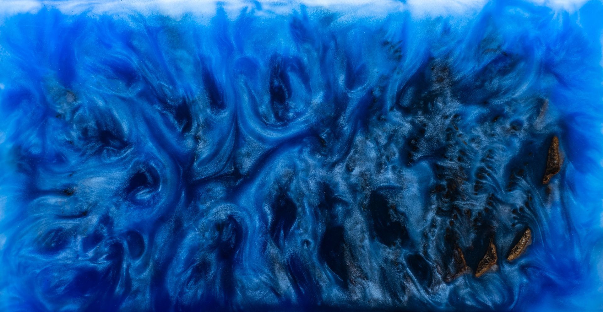 Swirling blue and dark resin with gold accents, resembling a celestial or oceanic abstract.