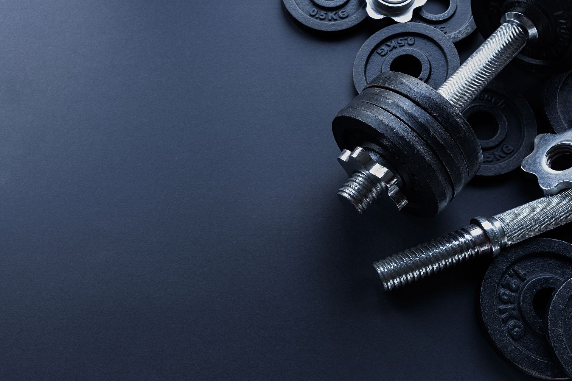 Woman laughing with eyes closed, mouth open, wearing a green shirt, against a white backdrop.