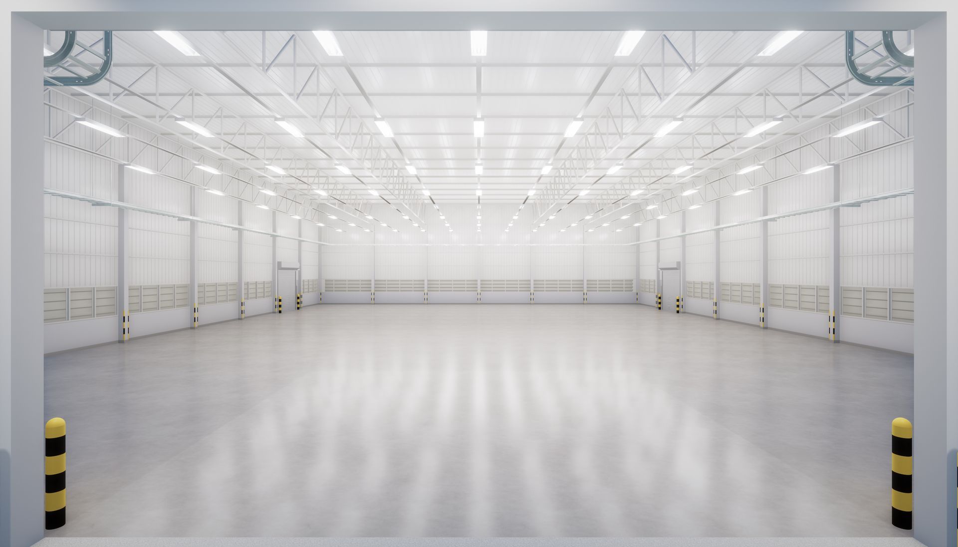 Empty, bright warehouse interior. White walls and ceiling, gray floor, overhead lights, open doorway.