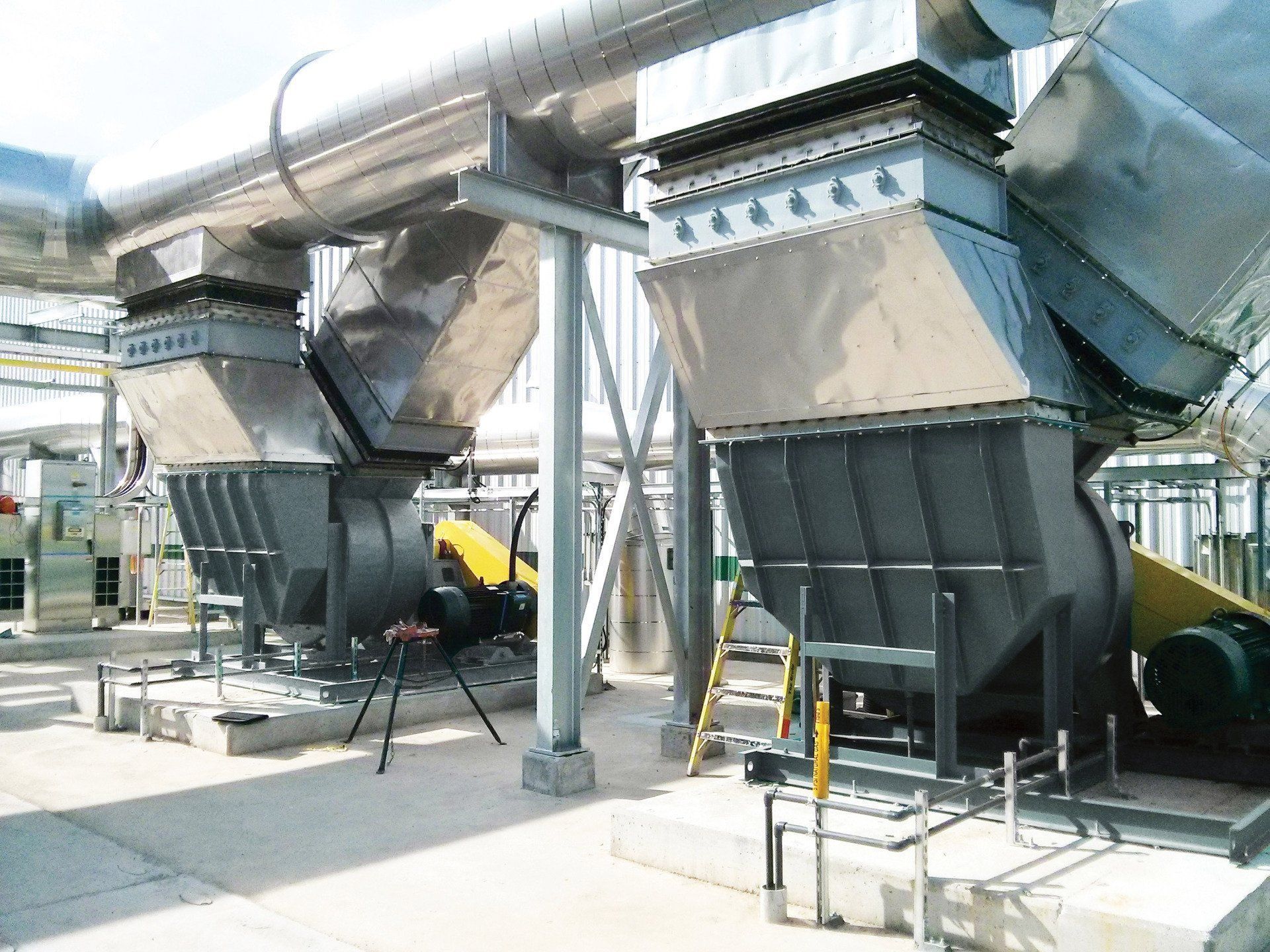 Large industrial ventilation units, gray metal, installed outdoors.