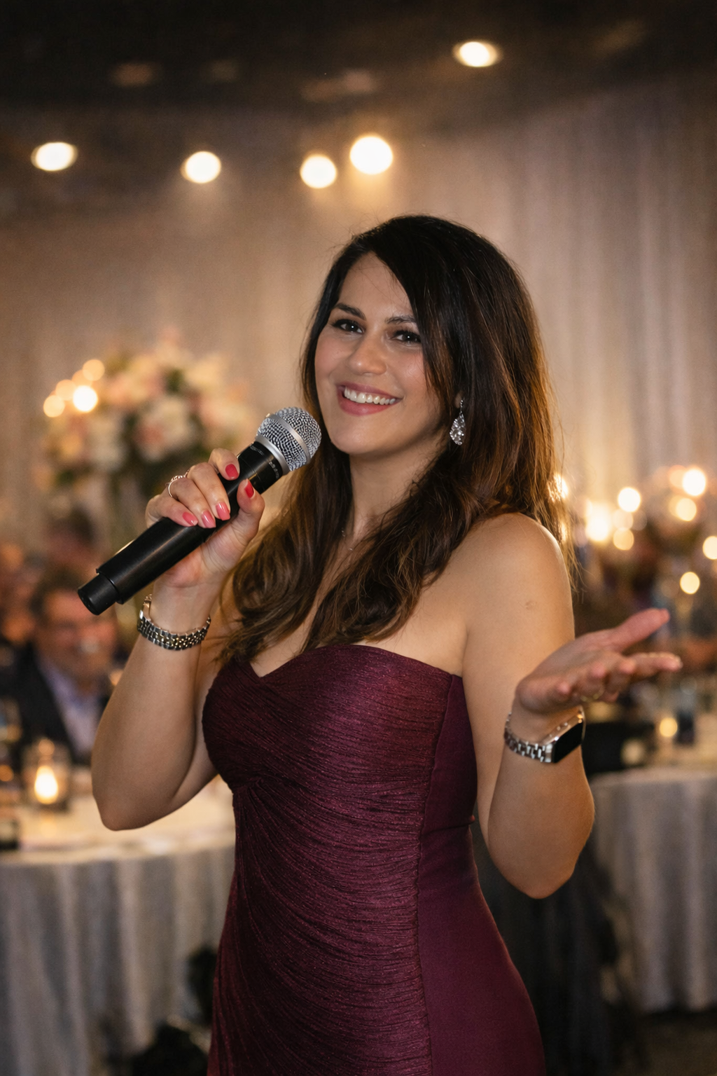 A man playing a guitar next to a woman singing into microphones