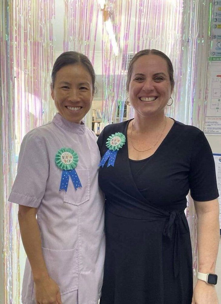 Two Women Are Posing For A Picture Together And Smiling — Barry Bennett Dental In Cairns, QLD