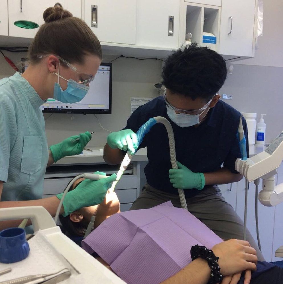 A Woman Is Getting Her Teeth Examined By A Dentist — Barry Bennett Dental In Earlville, QLD