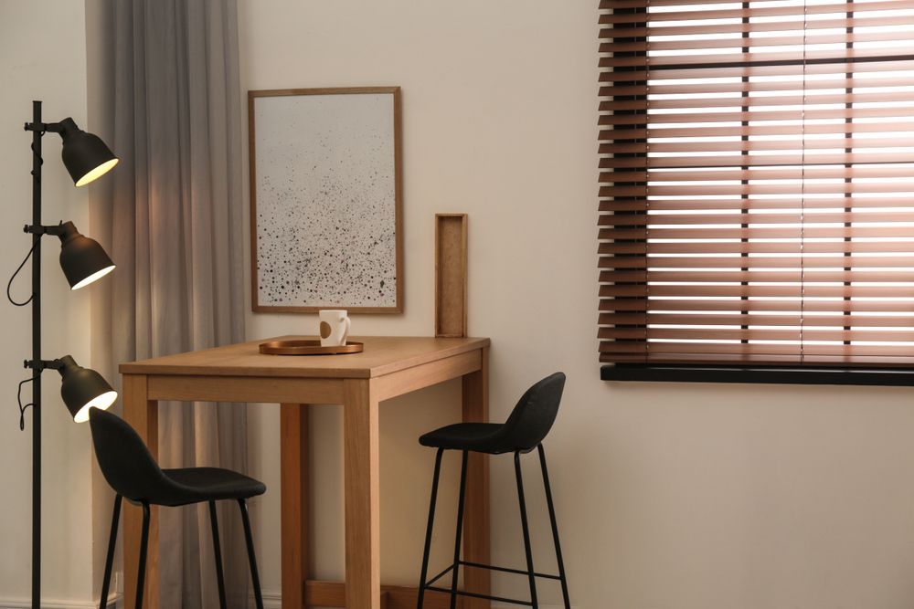 The Sun Is Shining Through the Blinds of A Window — Bay Blinds & Doors in Bateau Bay, NSW