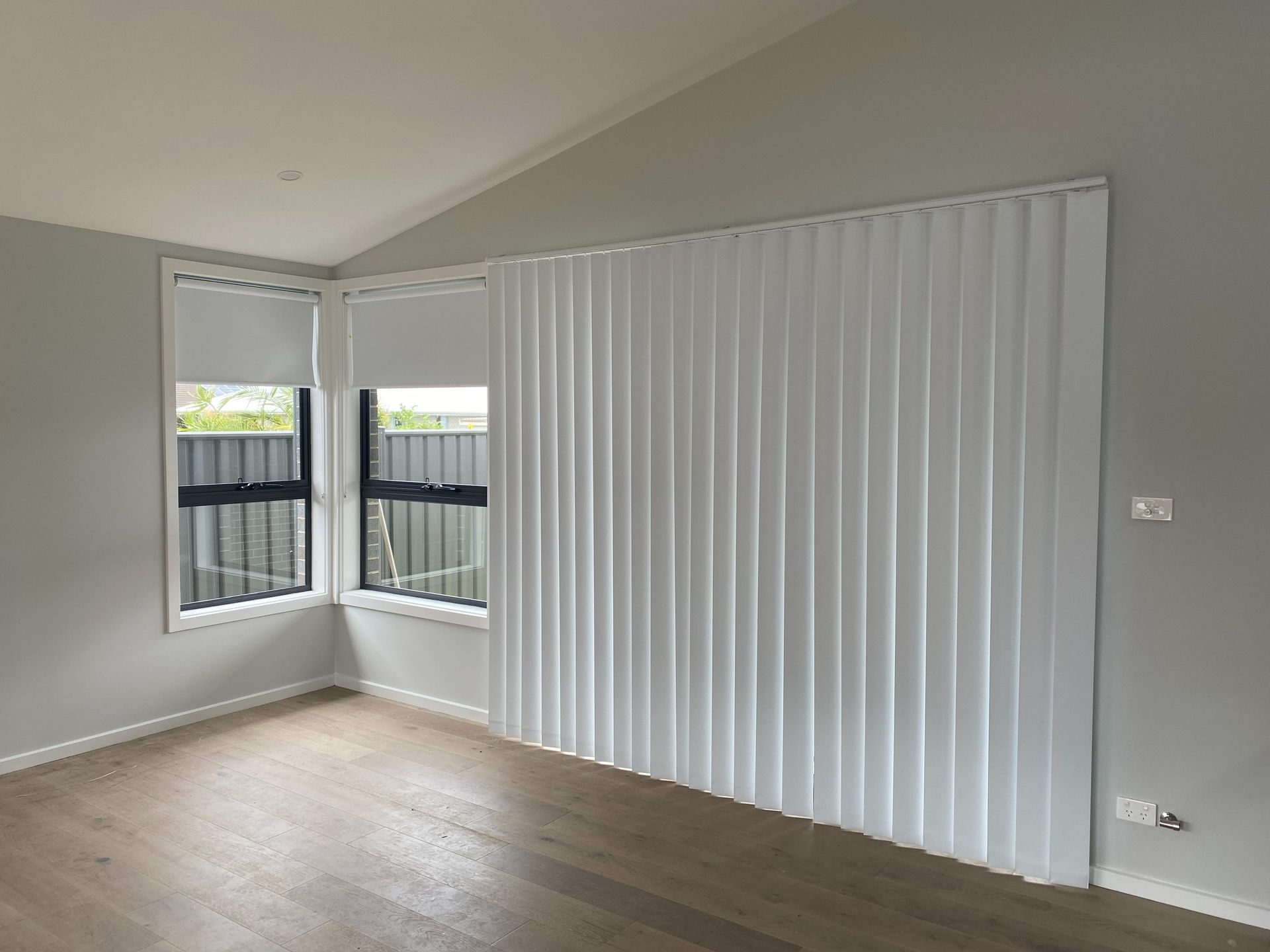 A Close up Of a Window with Blinds and A White Handle — Bay Blinds & Doors in Morisset, NSW