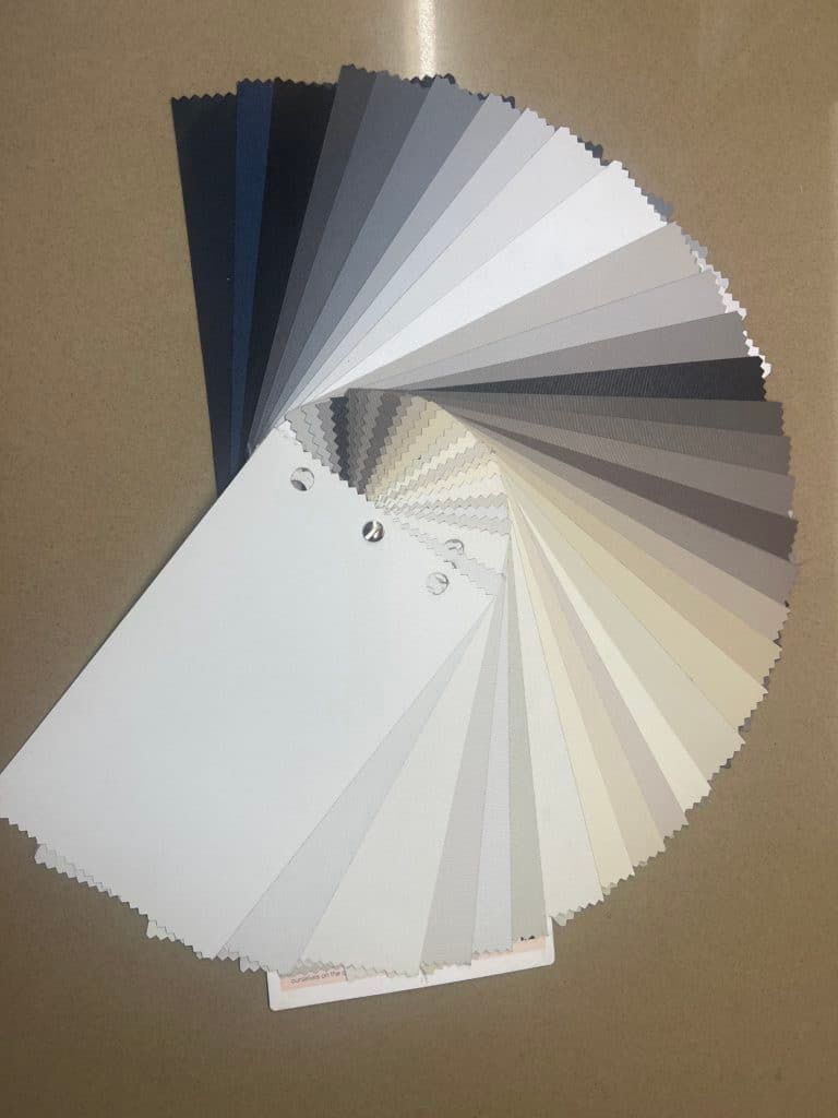 A Fan Shaped Display of Different Shades of White and Grey — Bay Blinds & Doors in Bateau Bay, NSW