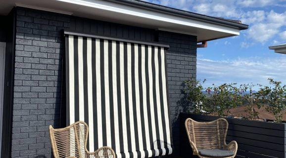 A House with A Gray Awning on The Side of It — Bay Blinds & Doors in Bateau Bay, NSW