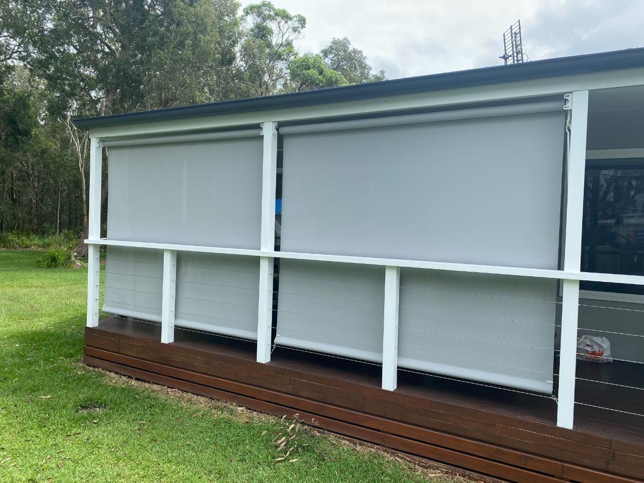 A House with A Deck and A Fence with Blinds on It — Bay Blinds & Doors in Bateau Bay, NSW
