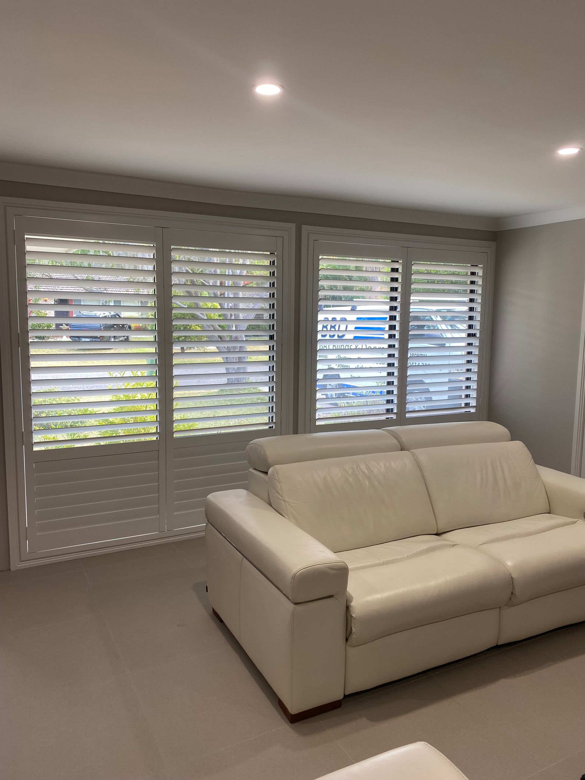 A Room with A Lot of Windows and Blinds on Them — Bay Blinds & Doors in Bateau Bay, NSW