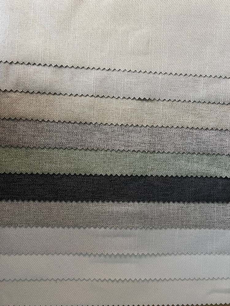 A Close Up of a Stack of Fabric Samples in Different Colors — Bay Blinds & Doors in Bateau Bay, NSW