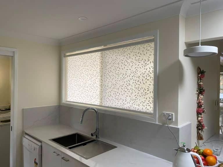 A Kitchen with A Sink and A Window with Blinds on It — Bay Blinds & Doors in Bateau Bay, NSW