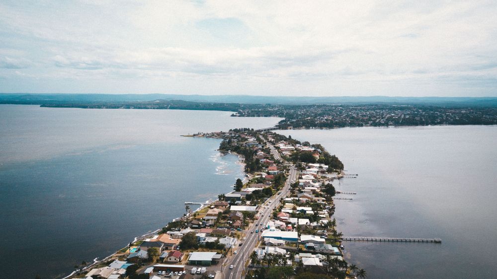 Aerial view of Toukley, Noraville suburbs on Central Coast with Budgewoi Lake and Cabbage Tree Harbour are in the background — Bay Blinds & Doors in Toukley, NSW