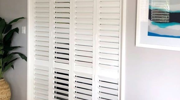 There Is a Picture on The Wall Above the Shutters — Bay Blinds & Doors in Bateau Bay, NSW