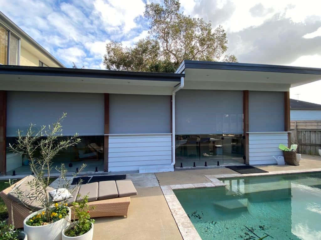 A House with A Swimming Pool in Front of It — Bay Blinds & Doors in Bateau Bay, NSW