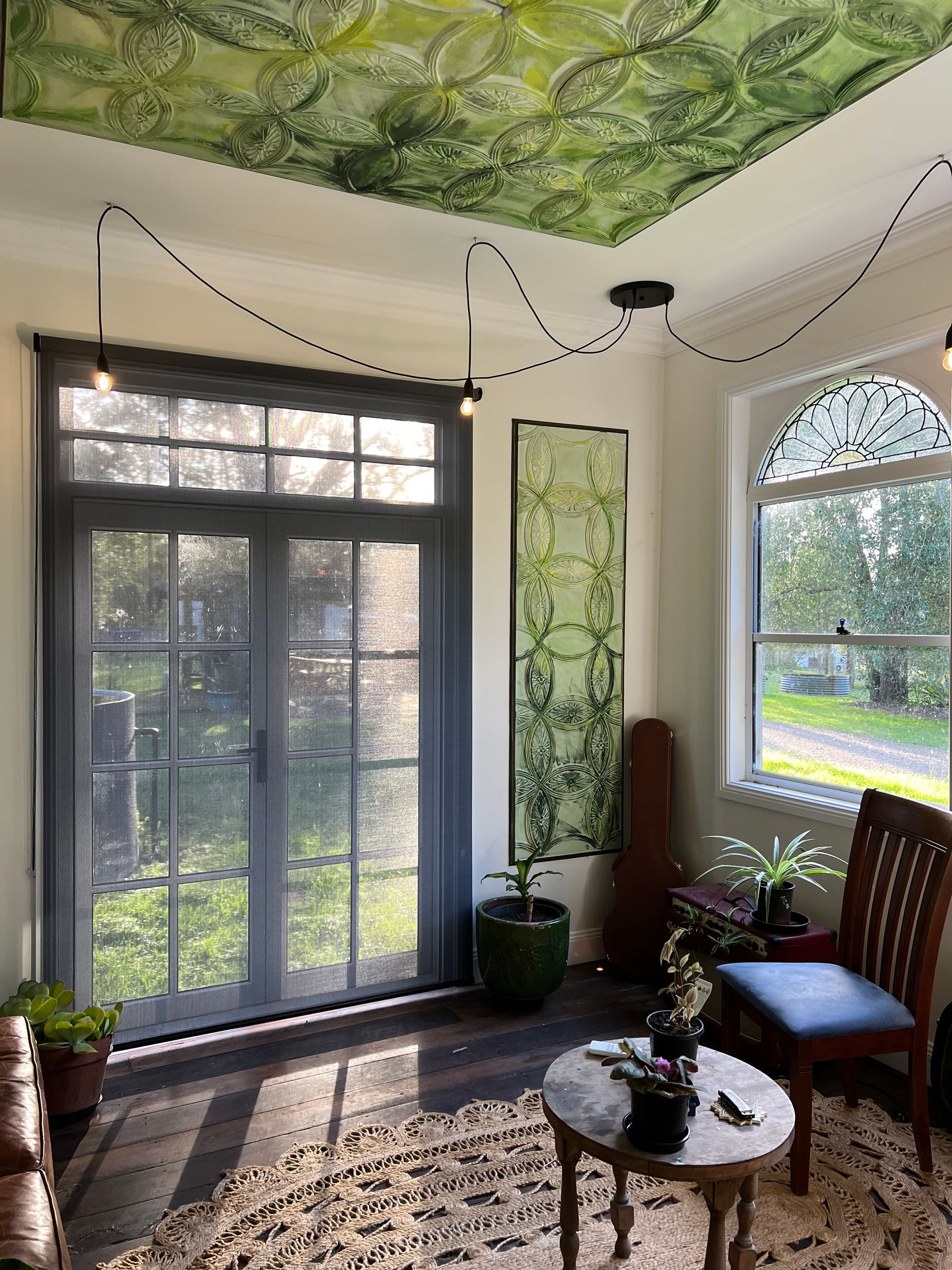 A Stuffed Giraffe Is Sitting on A Couch in Front of A Window — Bay Blinds & Doors in Saratoga, NSW