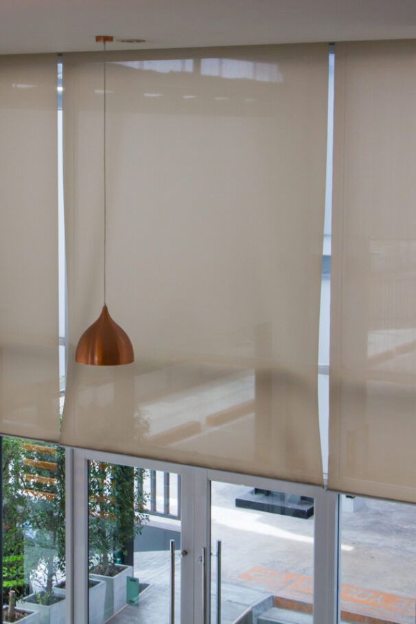 A Large Window with Blinds and A Pendant Light Hanging from The Ceiling — Bay Blinds & Doors in Bateau Bay, NSW