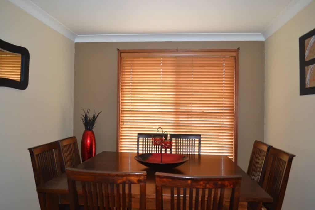 The Sun Is Shining Through the Blinds of A Window — Bay Blinds & Doors in Bateau Bay, NSW
