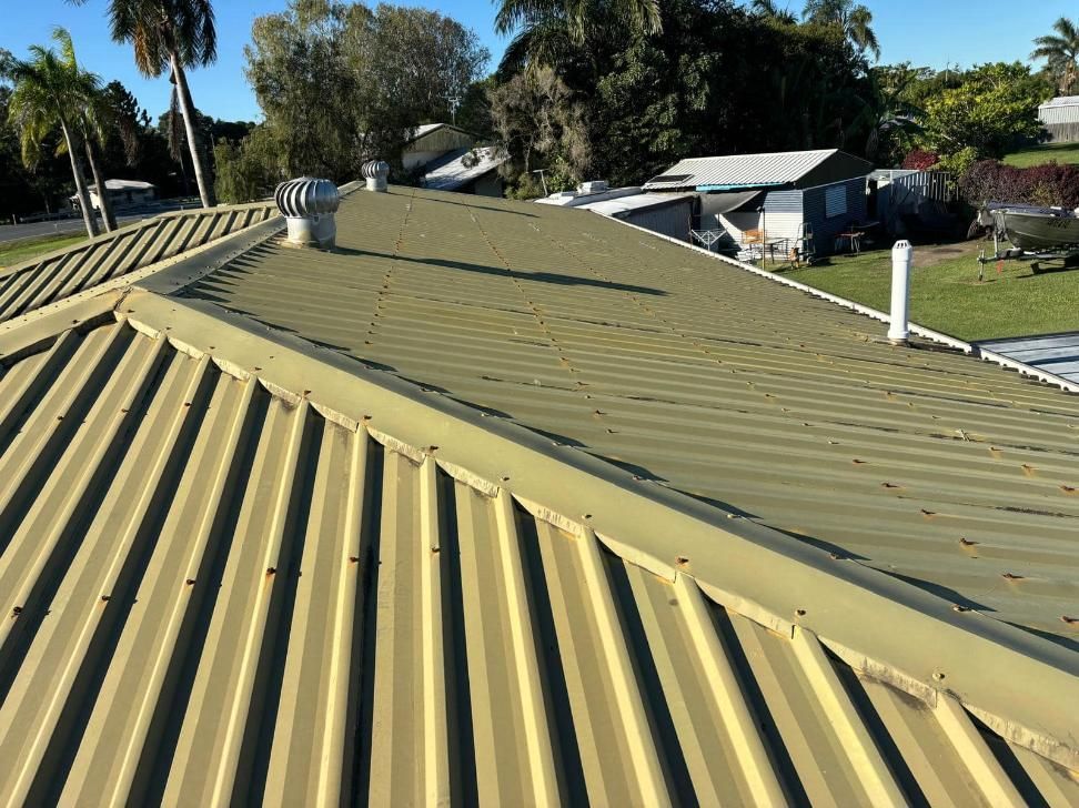The Roof of a House With a Metal Roof and a Chimney — Geiger Solutions In Mackay, QLD