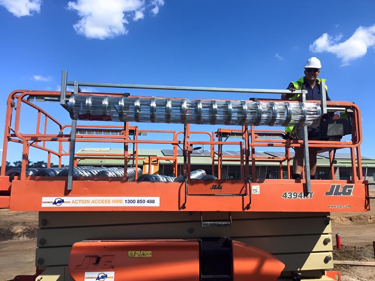 A Man is Sitting on Top of a Jlg Lift — Geiger Solutions In Bowen Basin, QLD