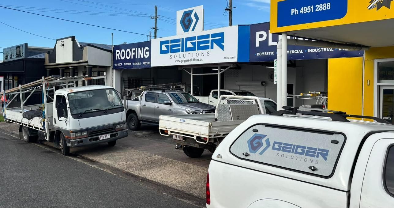 A Row of Trucks Are Parked in Front of a Building — Geiger Solutions In Mackay, QLD