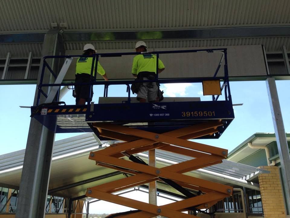 Two Men Are Working on a Scissor Lift — Geiger Solutions In Moranbah, QLD