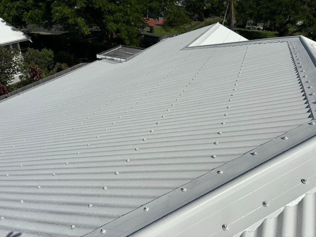 A Close Up of a White Roof With Trees in the Background — Geiger Solutions In Mackay, QLD