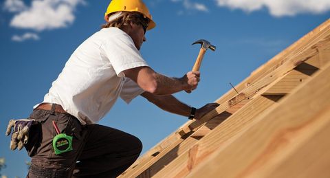 Man Constructing A Roof — Redding, CA — Eric B. Johnston Construction