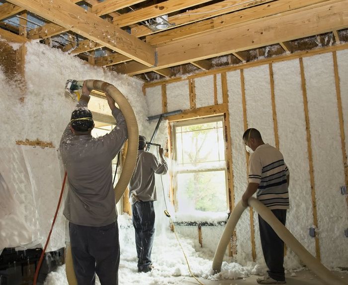 men installing foam insulation