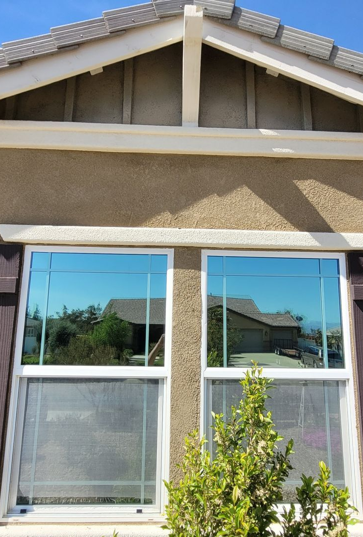 A living room with a fireplace and a large window